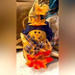 Handmade scarecrow on small round wood